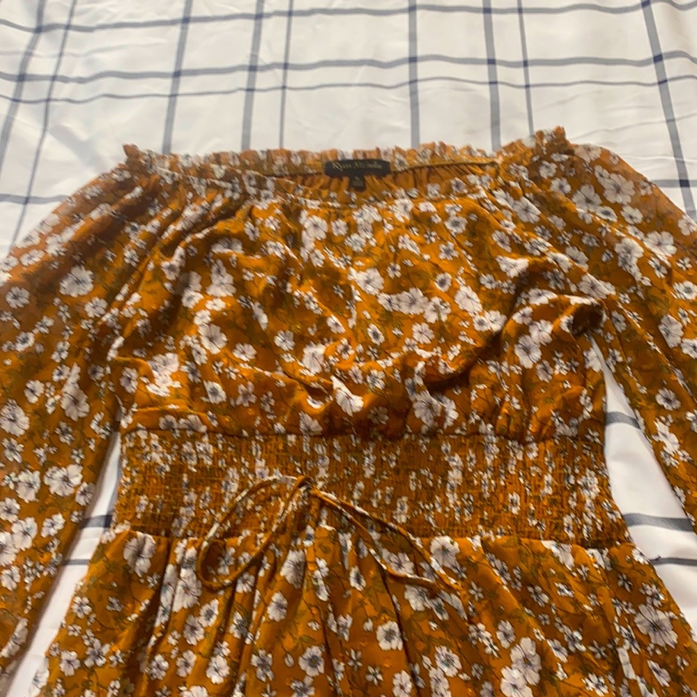 A  brown color  dress with white flowers